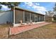 Screened-in patio with seating area and adjacent yard at 16029 Worthington N Blvd, Mascotte, FL 34753