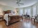 Main bedroom with large bed, wood floors, and window seating at 16841 Se 84Th Colerain Cir, The Villages, FL 32162