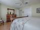 Bedroom with wood floors, dresser, and ceiling fan at 16841 Se 84Th Colerain Cir, The Villages, FL 32162