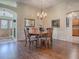 Spacious dining room with hardwood floors and a chandelier at 16841 Se 84Th Colerain Cir, The Villages, FL 32162