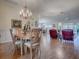 Elegant dining room with hardwood floors and a chandelier at 16841 Se 84Th Colerain Cir, The Villages, FL 32162