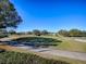 Landscaped golf course with walking path and clear blue sky at 16841 Se 84Th Colerain Cir, The Villages, FL 32162