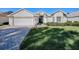 One-story home with a two-car garage and landscaped yard at 16841 Se 84Th Colerain Cir, The Villages, FL 32162