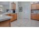 Kitchen boasts wood cabinets, granite countertops and tile flooring at 16841 Se 84Th Colerain Cir, The Villages, FL 32162