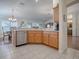 Kitchen features wood cabinets, a dishwasher, and granite countertops at 16841 Se 84Th Colerain Cir, The Villages, FL 32162