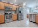 Modern kitchen with stainless steel appliances and wood cabinets at 16841 Se 84Th Colerain Cir, The Villages, FL 32162