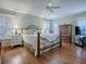 Main bedroom with hardwood floors, a ceiling fan, and plantation shutters at 16841 Se 84Th Colerain Cir, The Villages, FL 32162