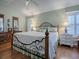 Main bedroom with hardwood floors, a king-size bed, and white nightstands at 16841 Se 84Th Colerain Cir, The Villages, FL 32162