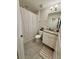 Clean bathroom with a shower/tub combo, granite vanity, and updated fixtures at 16929 Tesla Aly, Winter Garden, FL 34787