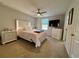 Spacious bedroom with plush carpeting and ceiling fan at 16929 Tesla Aly, Winter Garden, FL 34787