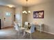 Dining area with glass top table and white chairs near entryway at 16929 Tesla Aly, Winter Garden, FL 34787