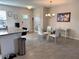 Kitchen and dining area view with granite counters and white cabinets at 16929 Tesla Aly, Winter Garden, FL 34787