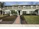 Two-story townhome with gray siding, brown shutters, and a brick walkway at 16929 Tesla Aly, Winter Garden, FL 34787