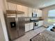 Stainless steel appliances and white cabinets in a modern kitchen at 16929 Tesla Aly, Winter Garden, FL 34787