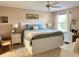 Spacious bedroom with a king-size bed and a ceiling fan at 17483 Se 74Th Netherclift Ter, The Villages, FL 32162