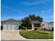 Single-story house with a two-car garage and well-maintained lawn at 17483 Se 74Th Netherclift Ter, The Villages, FL 32162