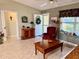 Living room with a comfortable armchair and a wooden coffee table at 17483 Se 74Th Netherclift Ter, The Villages, FL 32162