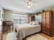 Spacious bedroom with wood floors, a built-in dresser, and large window at 2001 Cordero Ct, The Villages, FL 32159