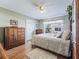 Cozy bedroom with wood floors, a large bed, and ample closet space at 2001 Cordero Ct, The Villages, FL 32159