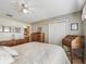 Comfortable bedroom with wood floors, a dresser, and access to a bathroom at 2001 Cordero Ct, The Villages, FL 32159