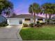 Charming single-story home with a two-car garage and lush landscaping at 2001 Cordero Ct, The Villages, FL 32159