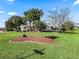 Landscaped front yard with palm trees and manicured lawn at 2001 Cordero Ct, The Villages, FL 32159