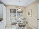 Kitchen breakfast nook with white chairs and a round table at 2001 Cordero Ct, The Villages, FL 32159