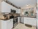 Modern kitchen with stainless steel appliances and granite countertops at 2001 Cordero Ct, The Villages, FL 32159