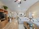 Open living space with hardwood floors, a dining area view, and built-in shelving at 2001 Cordero Ct, The Villages, FL 32159