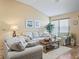 Cozy living room features light-colored furniture and hardwood floors at 2001 Cordero Ct, The Villages, FL 32159
