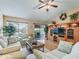Spacious living room with hardwood floors and a large TV at 2001 Cordero Ct, The Villages, FL 32159
