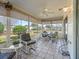 Relaxing sunroom with seating area and view of the backyard at 2001 Cordero Ct, The Villages, FL 32159