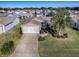 Aerial view of a single Gathering home with a driveway and landscaping at 2009 Claudio Ln, The Villages, FL 32159