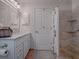 Bathroom with double vanity, marble countertop and shower at 2009 Claudio Ln, The Villages, FL 32159