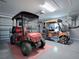 Two golf carts neatly parked in a well-lit garage at 2009 Claudio Ln, The Villages, FL 32159