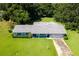 Aerial view of a ranch home with a large lawn at 2010 Hollywood Dr, Leesburg, FL 34748