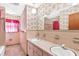 Bathroom with double vanity and pink tile at 2010 Hollywood Dr, Leesburg, FL 34748