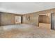 Spacious living room featuring wood paneled walls and wall-to-wall carpeting at 2010 Hollywood Dr, Leesburg, FL 34748