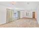 Living room with large window and view, carpeted floor at 2010 Hollywood Dr, Leesburg, FL 34748