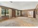 Living room with wood paneling and large windows at 2010 Hollywood Dr, Leesburg, FL 34748