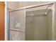 Shower stall with olive green tile and etched glass door at 2010 Hollywood Dr, Leesburg, FL 34748