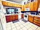 Well-equipped kitchen with ample wood cabinets and tile flooring at 204 Lori Ct, Umatilla, FL 32784