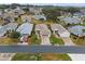 Aerial view of a single-story house with a yard and driveway at 21122 Lionheart Dr, Leesburg, FL 34748