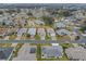 Aerial view of a single-story house with a yard and driveway at 21122 Lionheart Dr, Leesburg, FL 34748