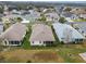 Aerial view showcasing the rear of the house with a screened enclosure at 21122 Lionheart Dr, Leesburg, FL 34748