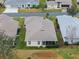 Aerial view showcasing the rear of the house with a screened enclosure at 21122 Lionheart Dr, Leesburg, FL 34748