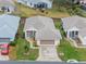 Aerial view of a single-story house with a two-car garage and well-maintained lawn at 21122 Lionheart Dr, Leesburg, FL 34748