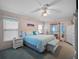 Spacious Primary bedroom with light blue bedding and ample closet space at 21122 Lionheart Dr, Leesburg, FL 34748