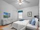 Cozy bedroom with ceiling fan, dresser, and soothing decor at 21122 Lionheart Dr, Leesburg, FL 34748
