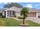 Single-story house with a screened porch and palm tree at 21122 Lionheart Dr, Leesburg, FL 34748